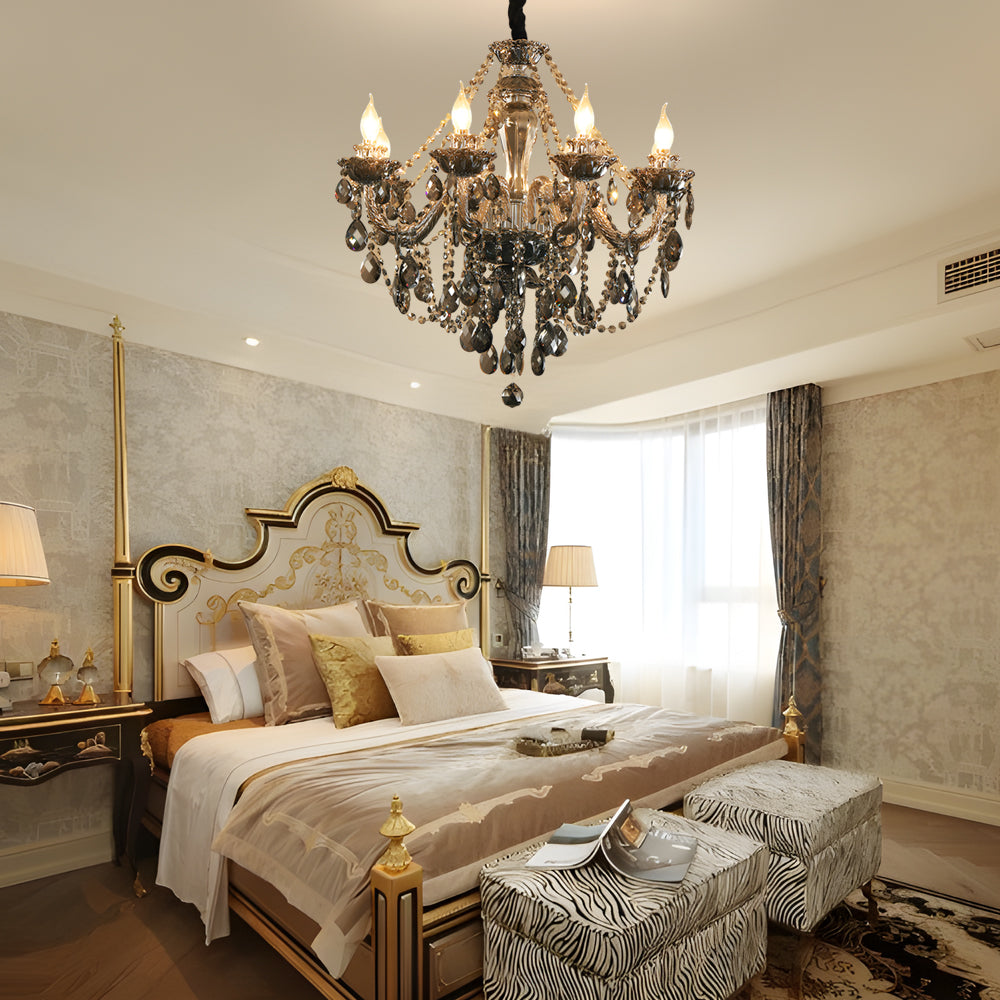 Black glass candlelight chandelier hanging in a classic bedroom with a gold-trimmed bed and warm decor.
