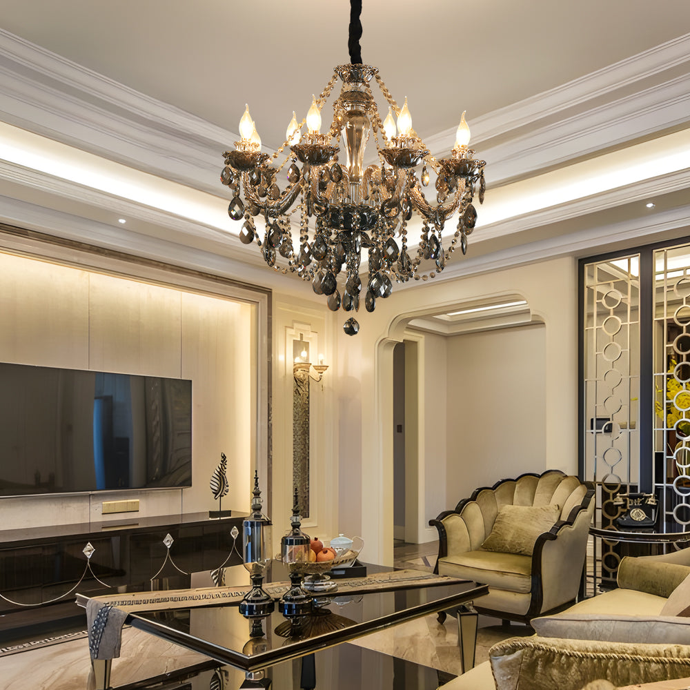 Black glass candlelight chandelier hanging in a luxury living room with sofas, TV wall, and warm lighting.