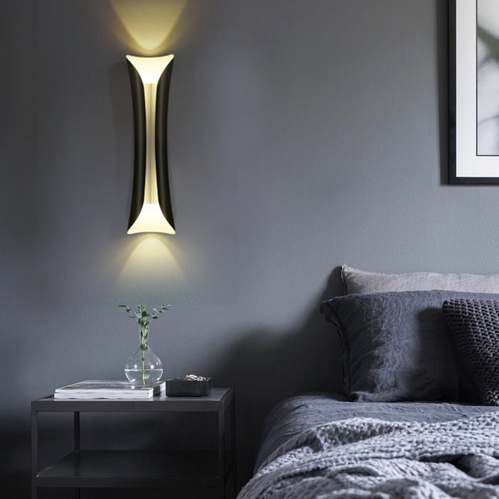 Black and gold indoor up down wall lights in contemporary bedroom setting.