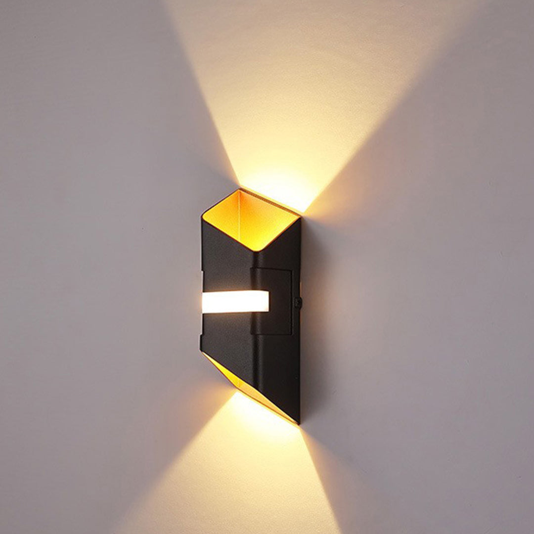 Black and gold wall light creating bidirectional lighting patterns on modern interior wall