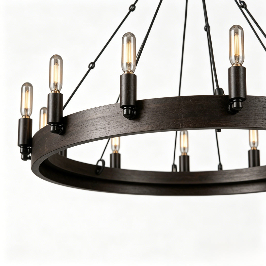 Black iron chandelier close-up showing candle-style bulbs and textured iron ring craftsmanship.