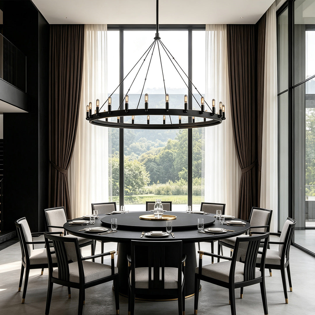 Black iron chandelier displayed above a formal dining table in a dramatic modern dining space.
