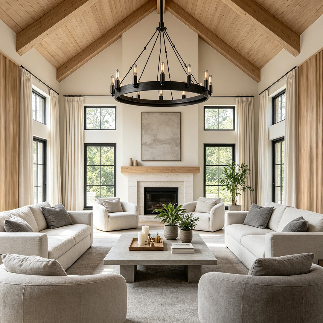 Black iron chandelier installed in a vaulted living room with rustic modern architectural details.