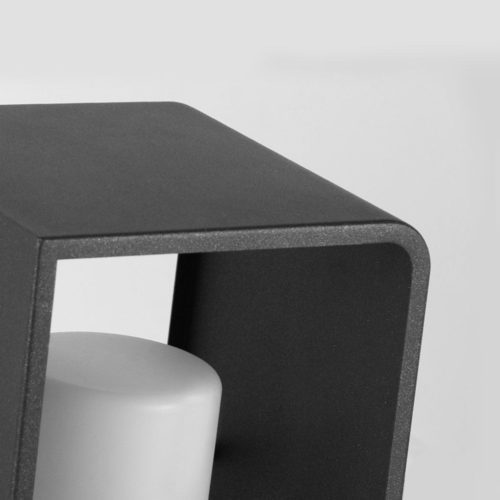 Black lantern outdoor light with cylindrical candle holder, detailed view of top edge.