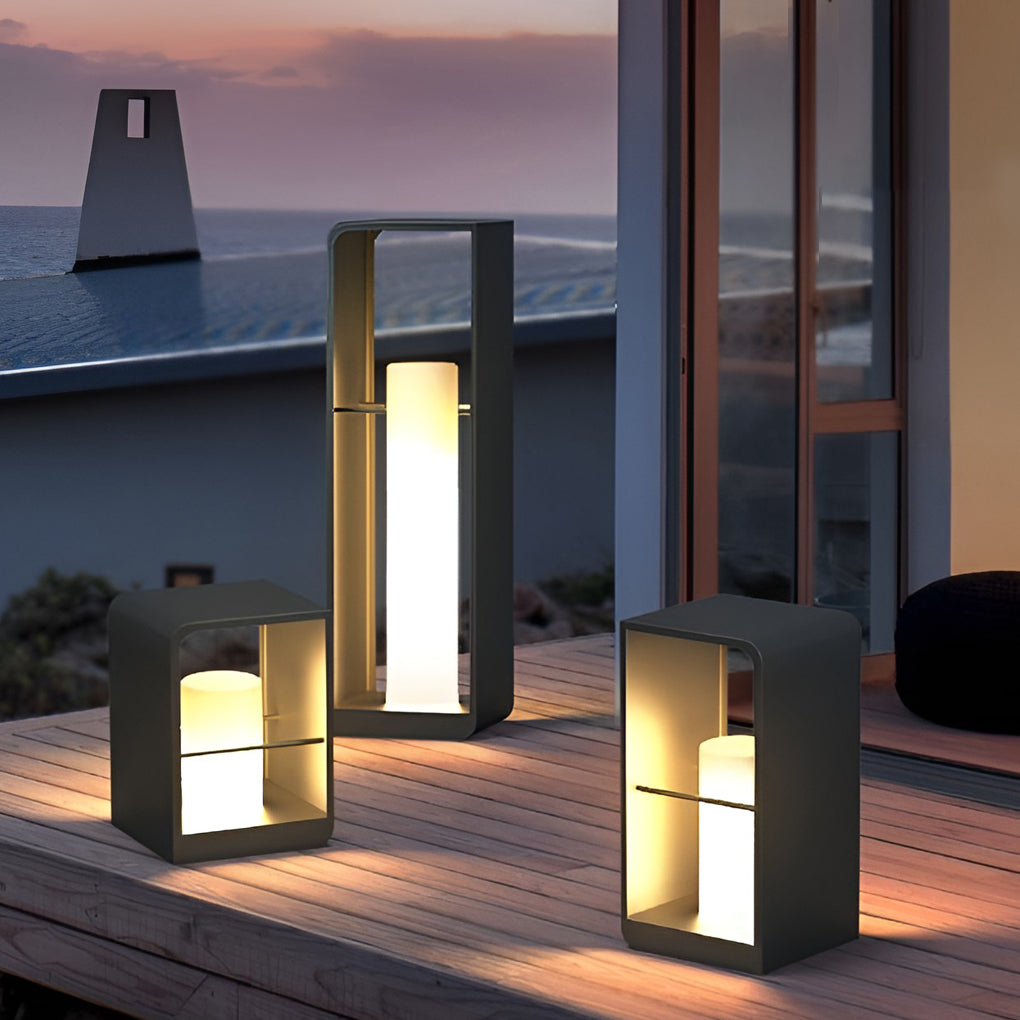 Black lantern outdoor light with modern geometric design, placed on wooden deck near pool at dusk.