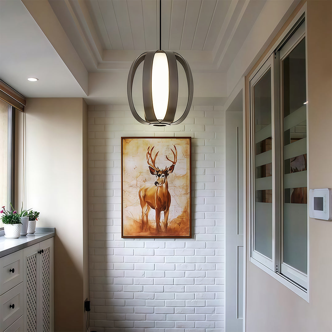 Black lantern pendant light creating focal point in neutral hallway with deer artwork.
