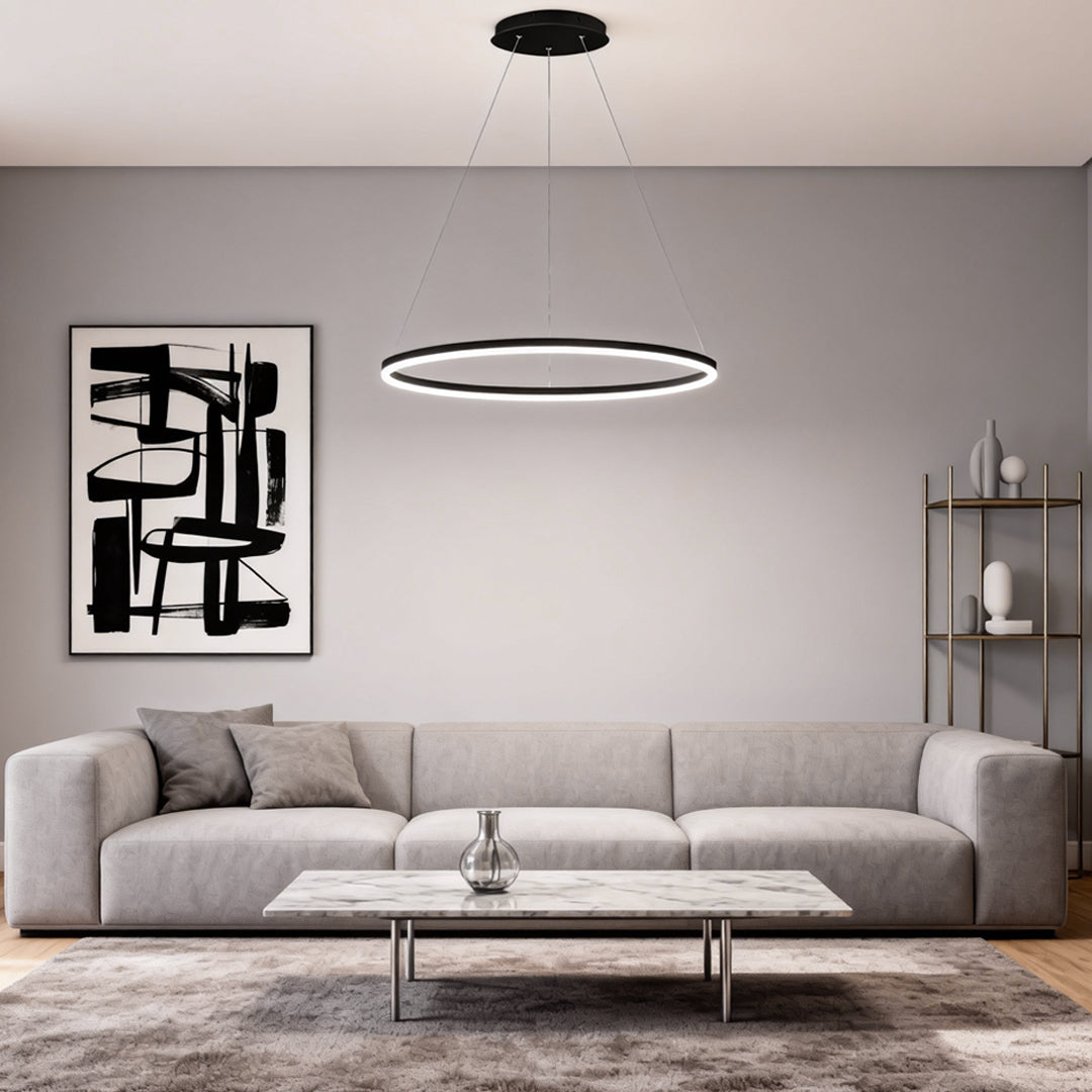 Black LED ring chandelier centered above a modern gray sofa in a contemporary interior.