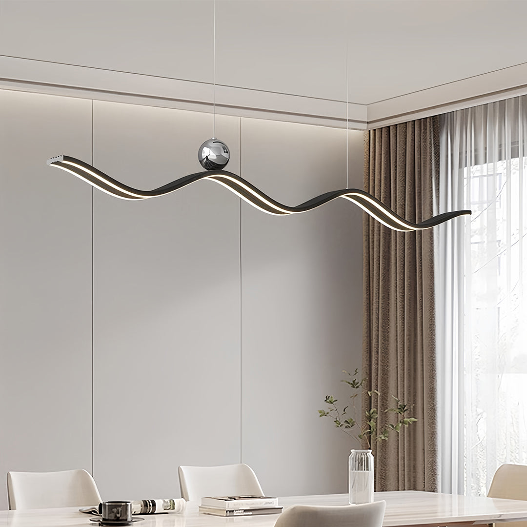 Black modern wave chandelier with integrated LED light strip, perfect for a long dining table setting.