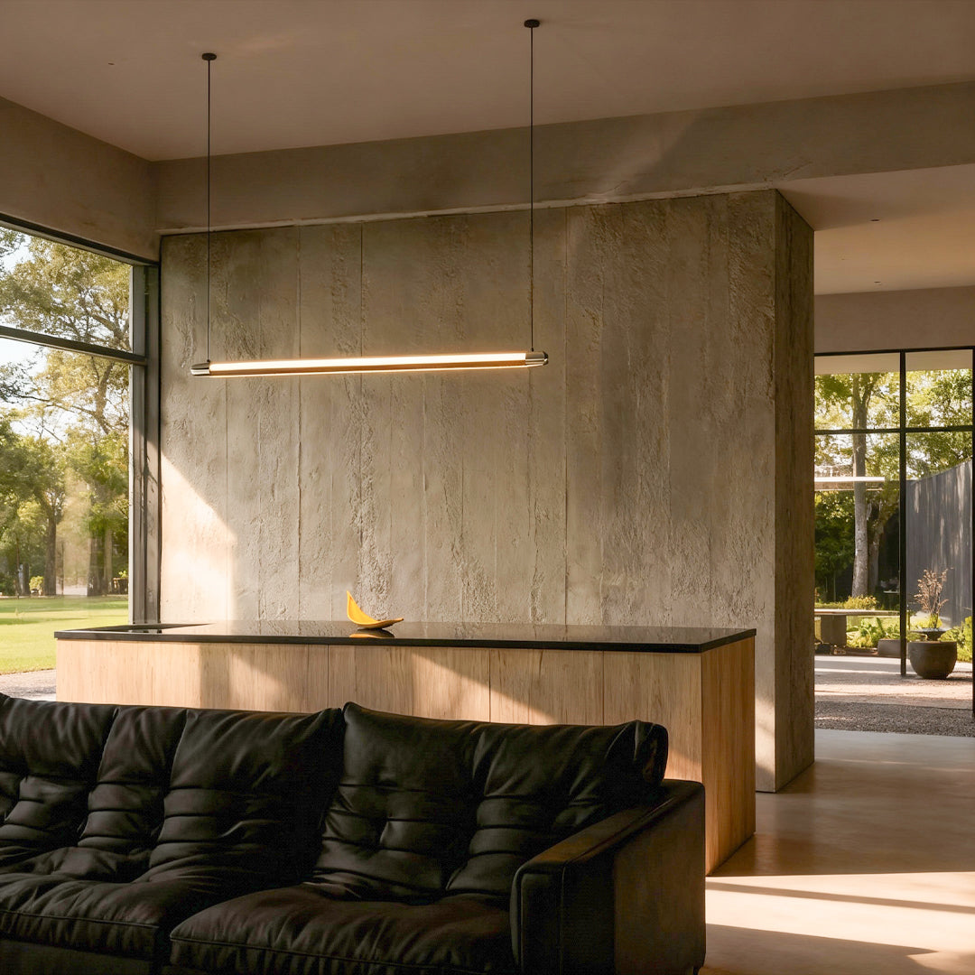 Black linear suspension light centered above conference table in contemporary meeting room with concrete walls