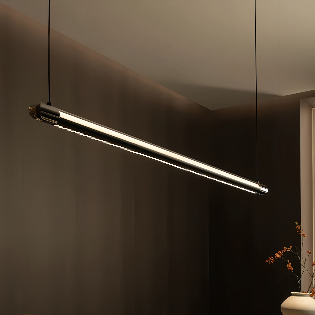 Black linear suspension light illuminating dark hallway with dramatic angular positioning creating striking lighting effect