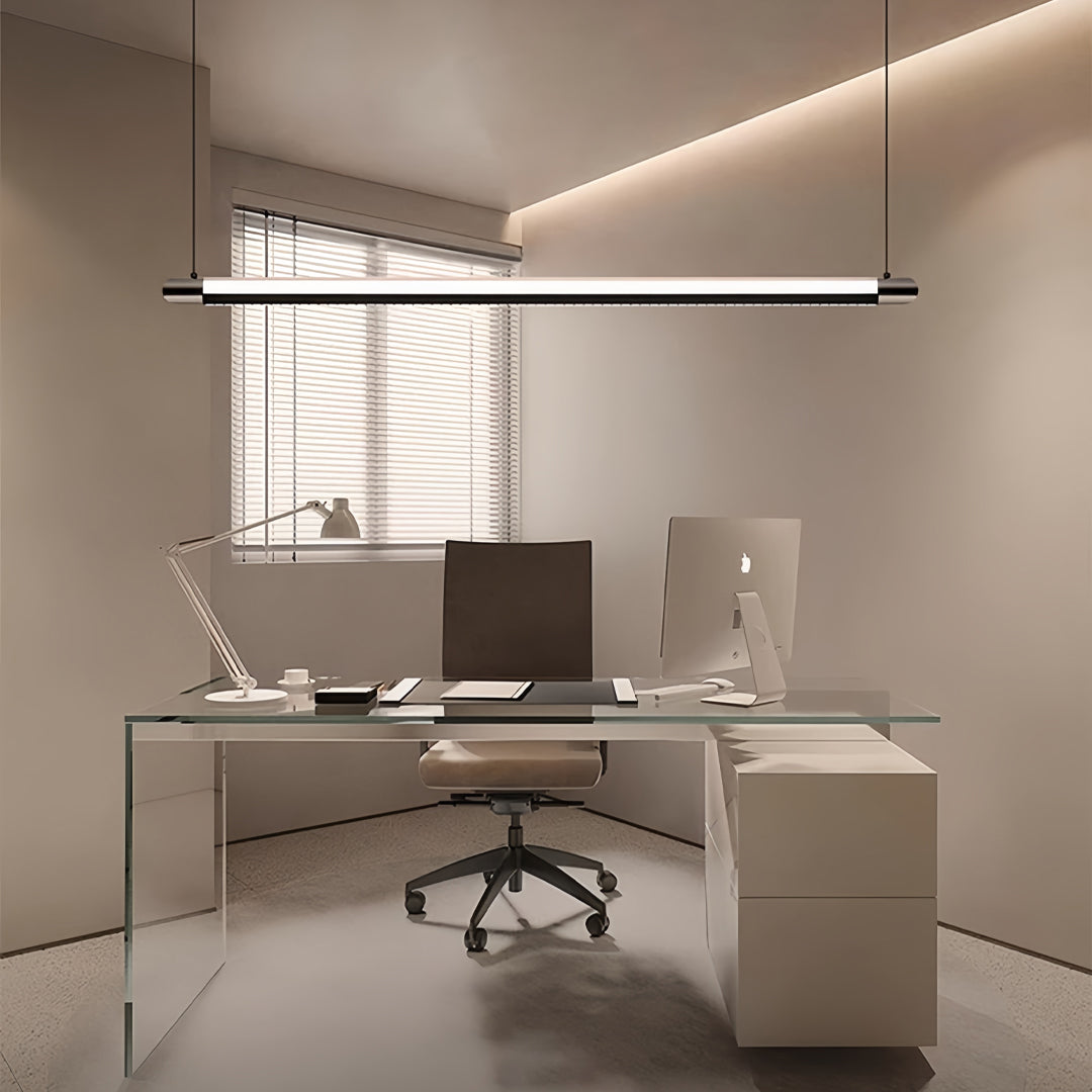 Black linear suspension light suspended above modern white office desk providing focused task lighting