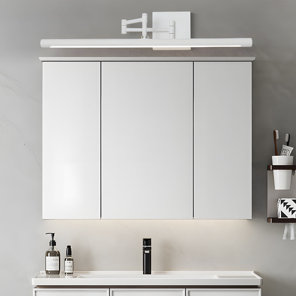 Black linear vanity light above a minimalist bathroom cabinet