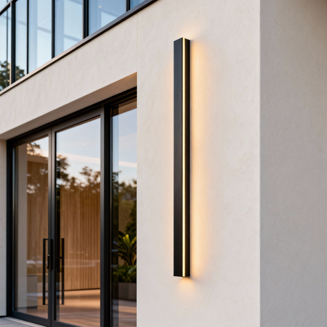 Black linear wall light enhancing a contemporary outdoor space with warm linear illumination.