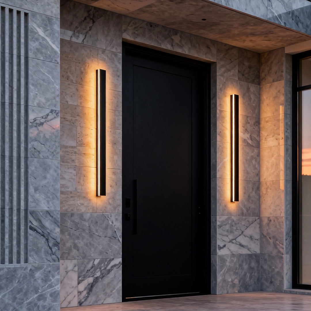 Black linear wall light providing soft light in a modern interior.