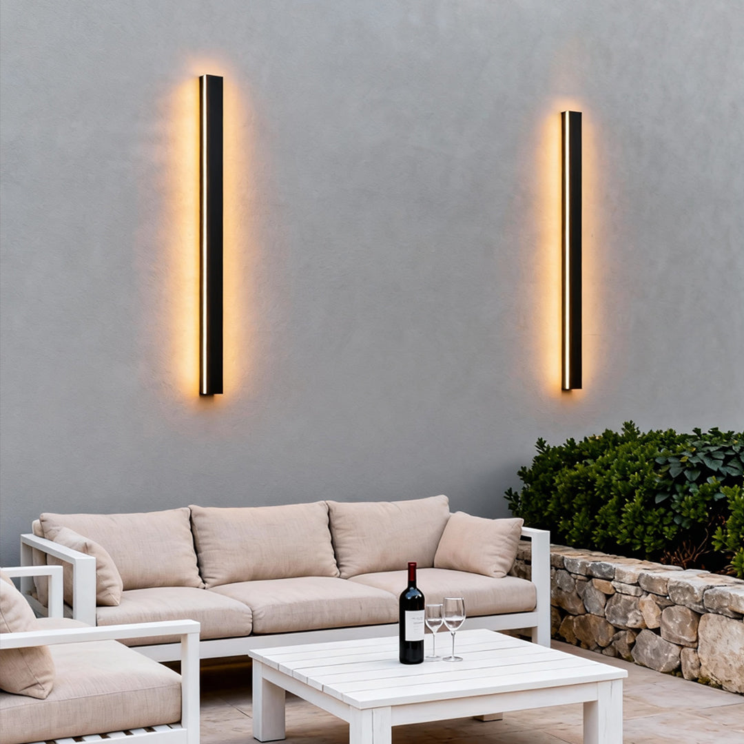 Black linear wall light enhancing a stylish dining area with ambient light.