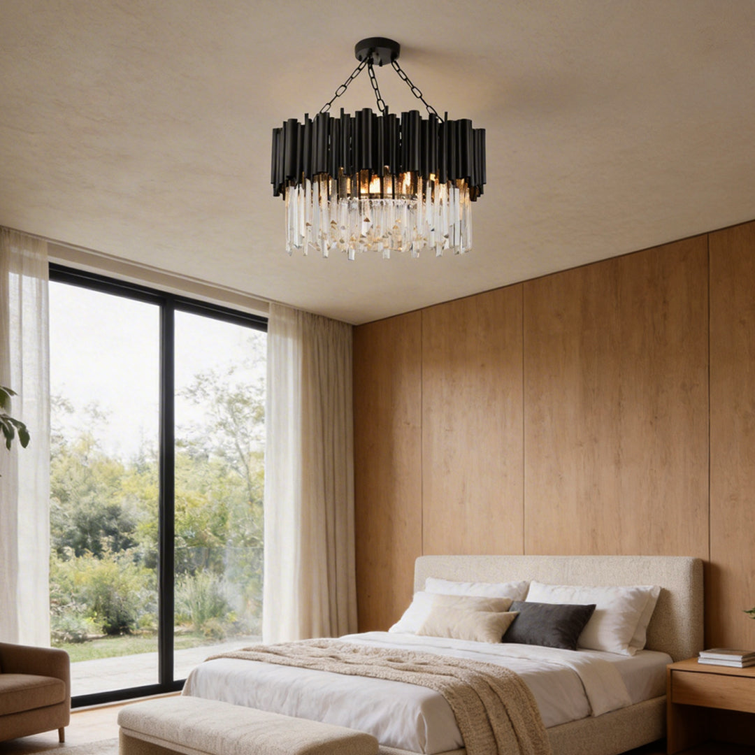 Black metal and crystal chandelier providing elegant lighting in a contemporary bedroom.