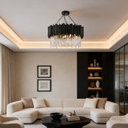 Black metal and crystal chandelier with a modern design, illuminating a stylish living room.