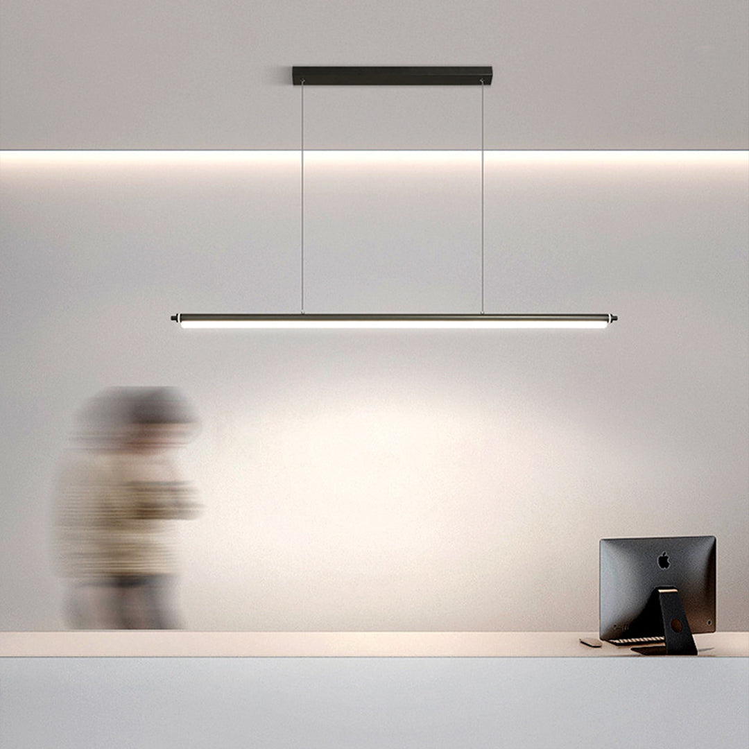 Black metal pendant light creating ambient illumination in modern minimalist kitchen interior
