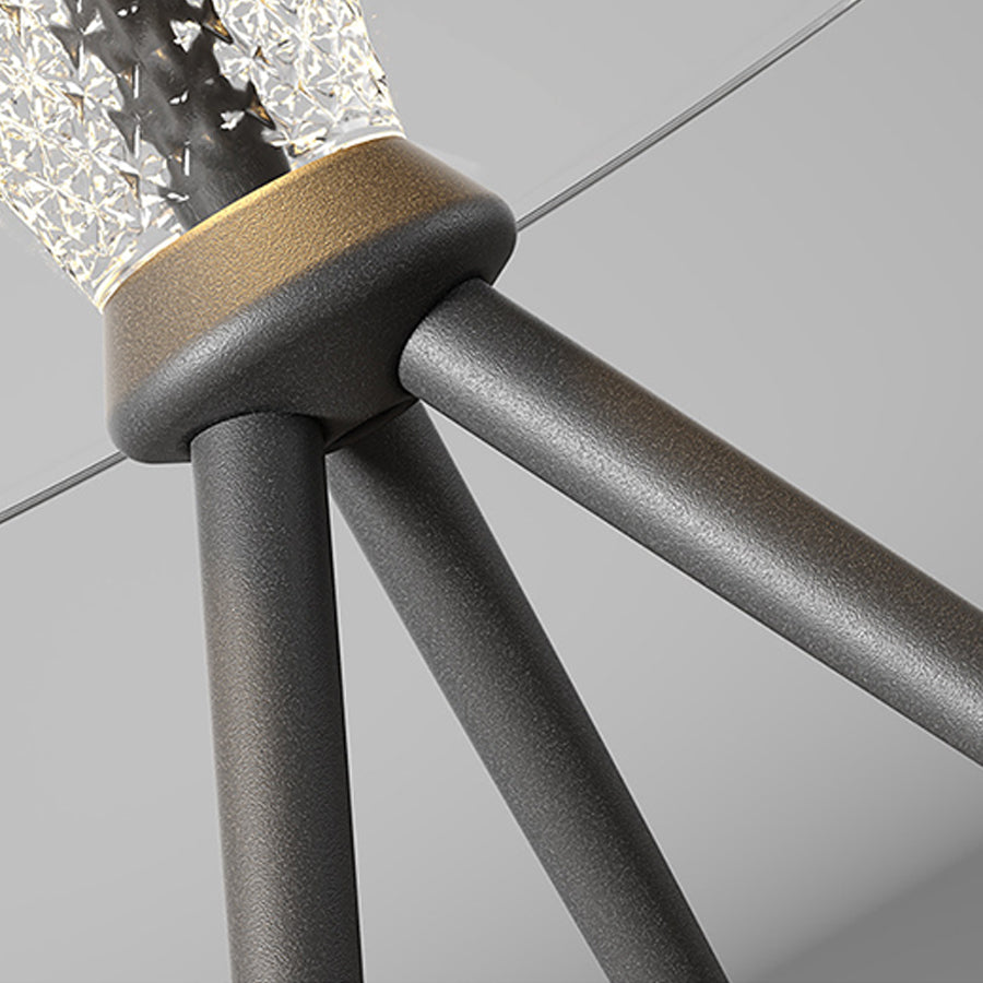 Close-up detail of black metal tripod legs supporting modern lighting fixture base