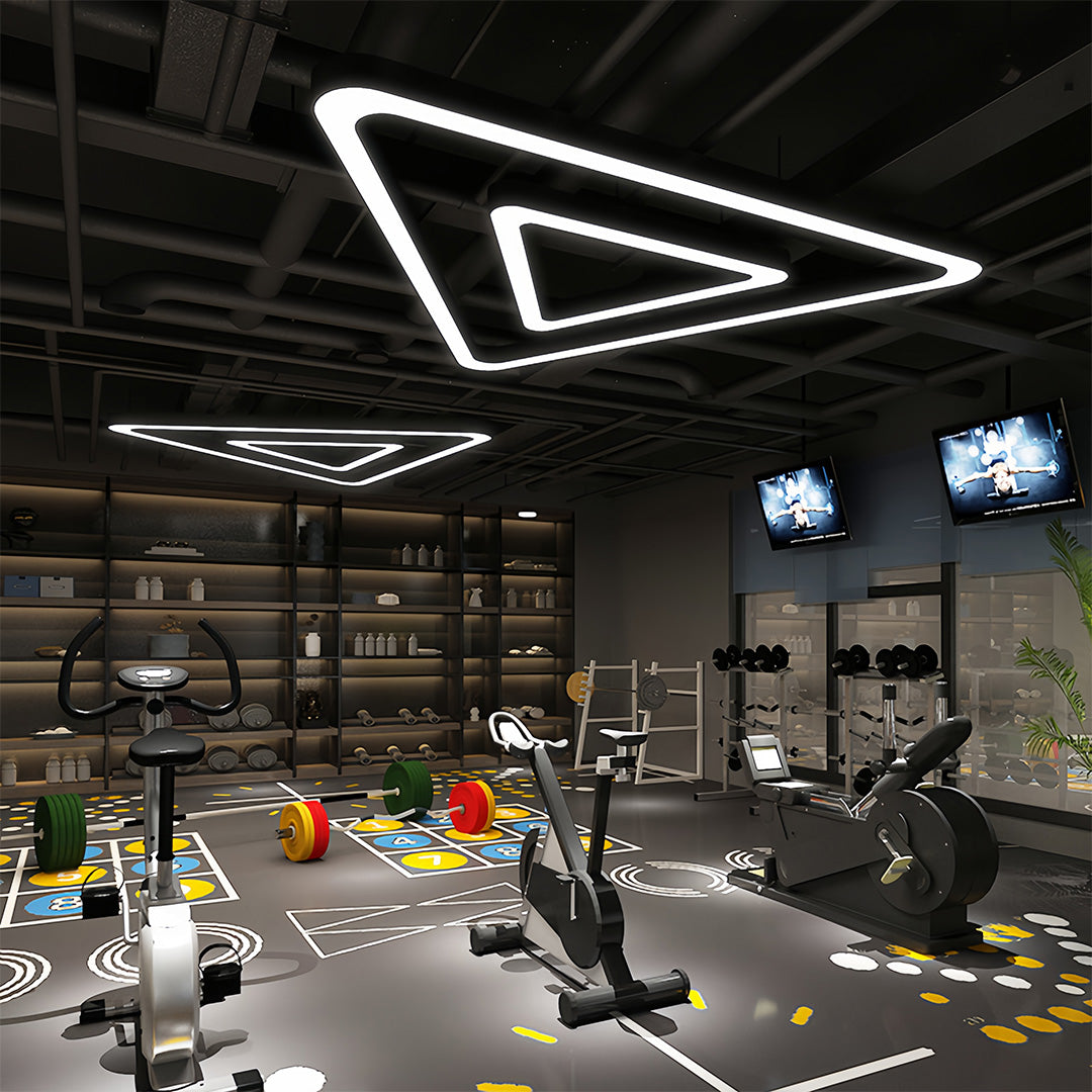 A large black modern chandelier illuminating a spacious modern interior, adding elegance to the room.