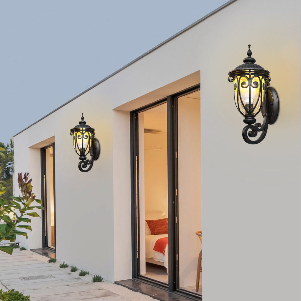 Black outdoor lantern sconce close up, highlighting the detailed metalwork and glass panels.