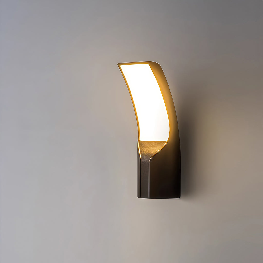 Sleek black outdoor light mounted on a stone wall, casting a soft and inviting light for a modern home.