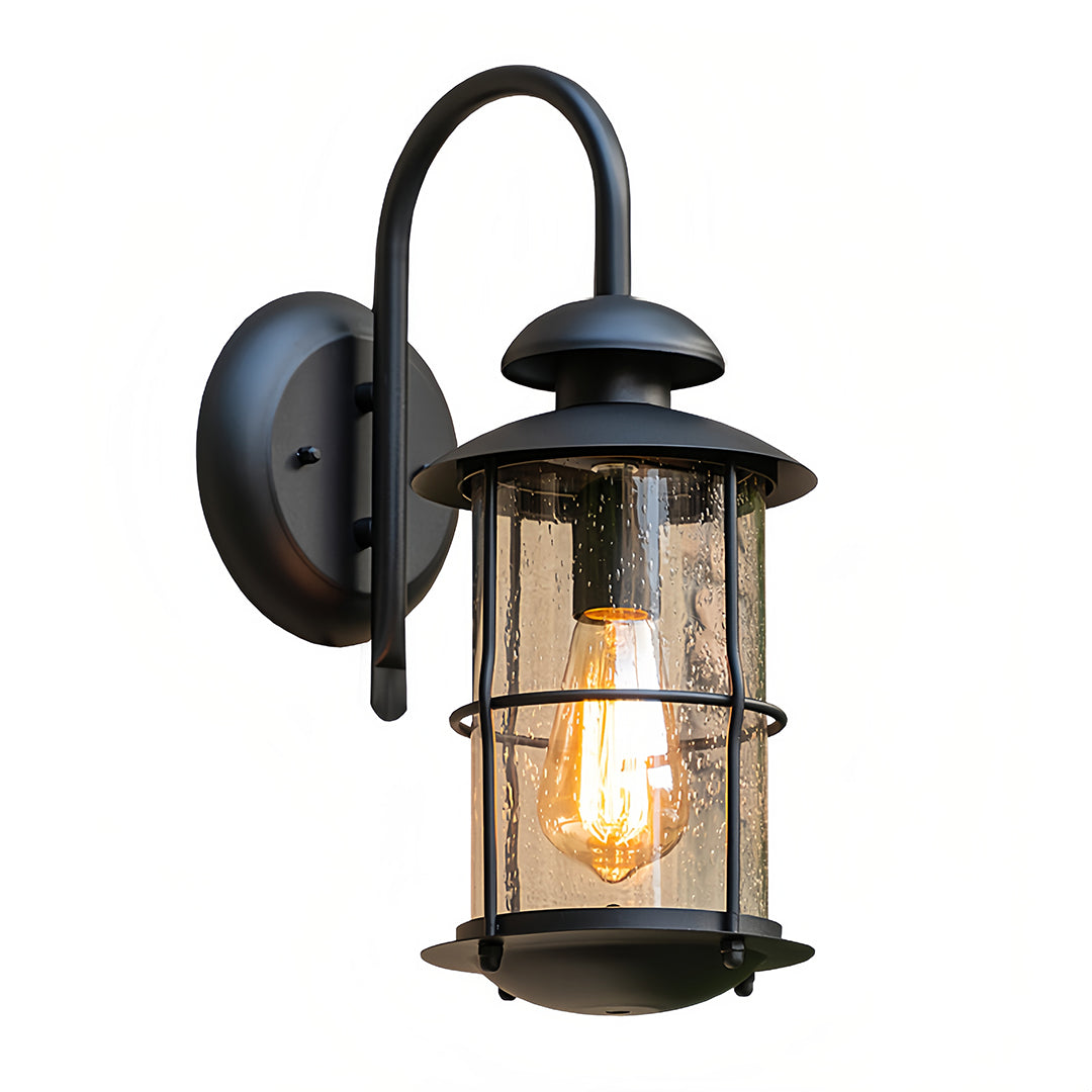 Outdoor wall mount light fixtures featuring a black metal frame and seeded glass shade.