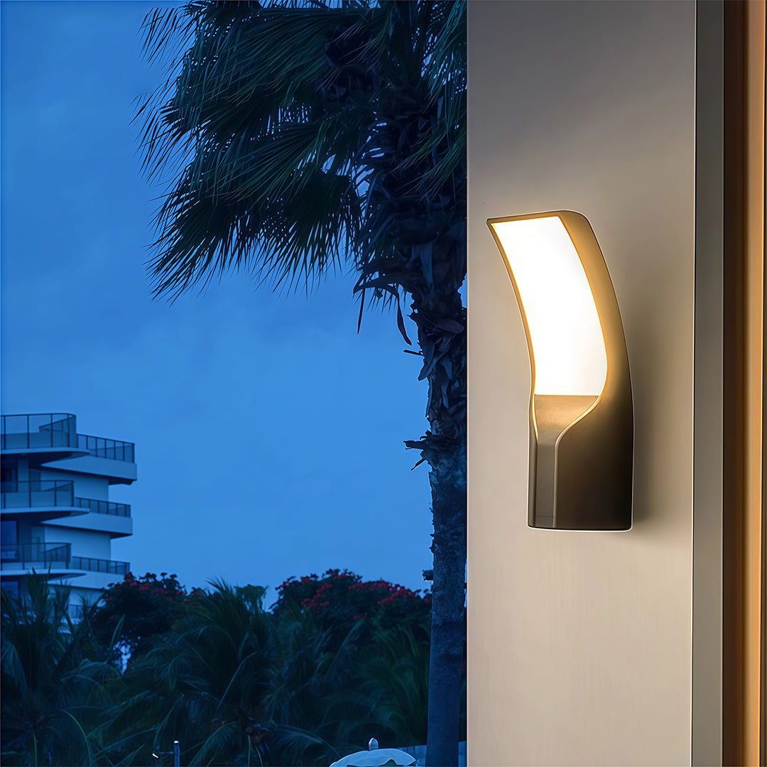 Black outdoor wall sconce installed on the exterior, offering a contemporary lighting solution for an outdoor space.