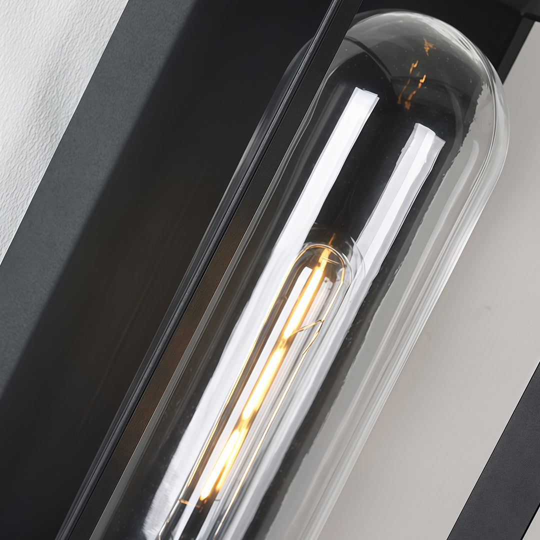 Black outdoor wall sconce modern interior detail showing vintage filament bulb and metal frame