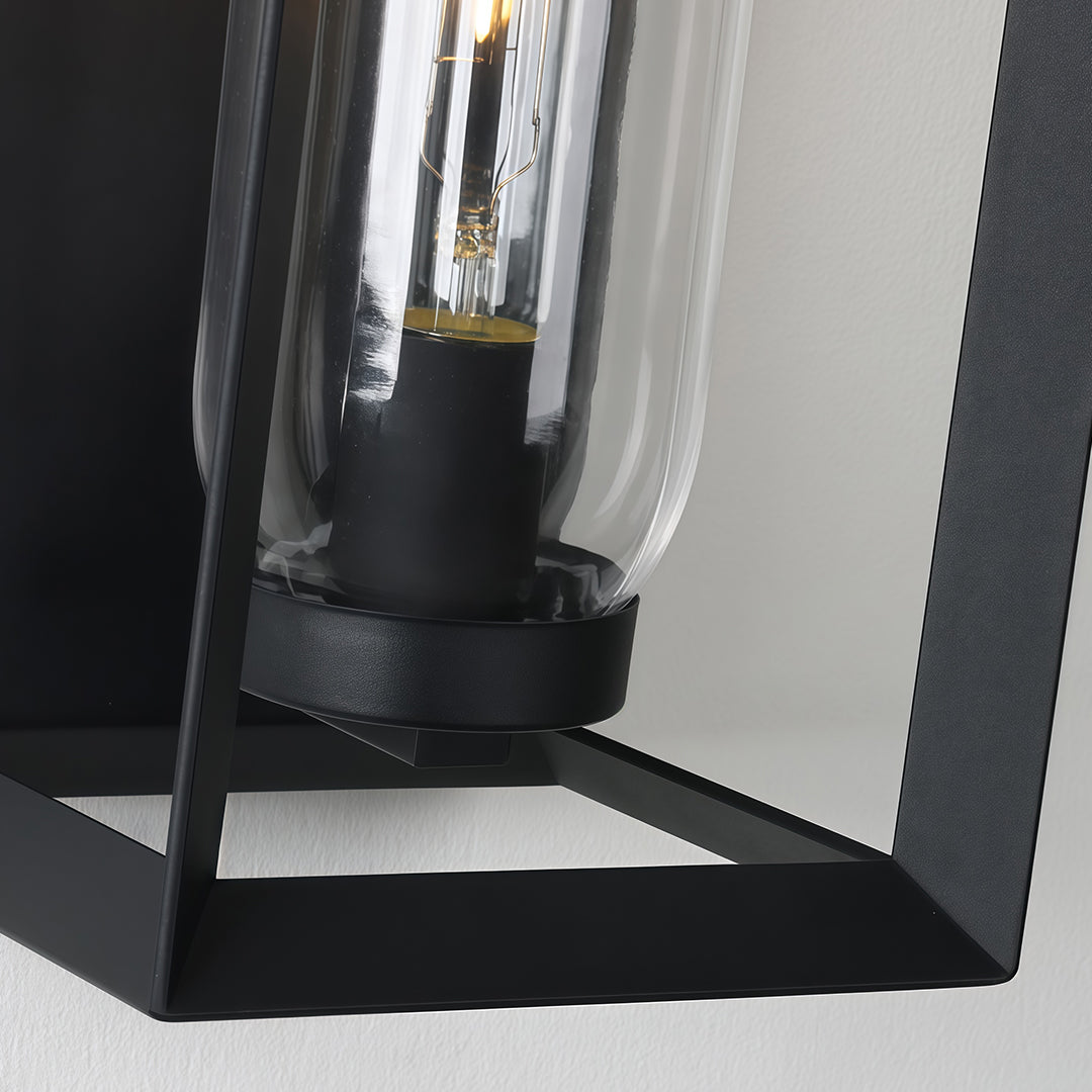 Close-up detail of black outdoor wall sconce modern mounting hardware and frame construction