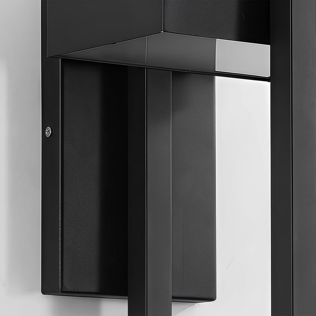 Close up detail of ribbed glass diffuser on an black outdoor wall sconce modern.