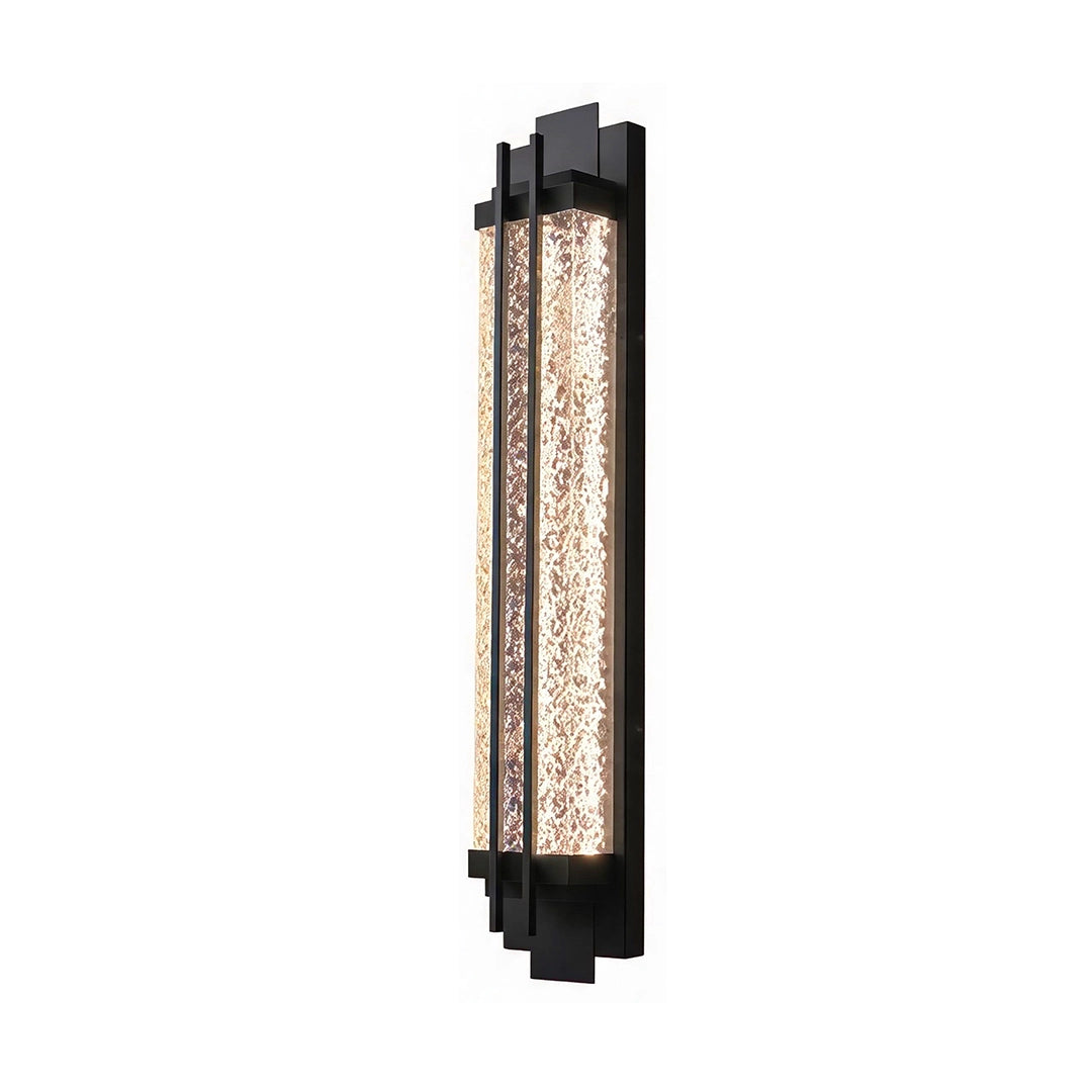 Black outside wall lights with an elongated black frame and warm glowing textured glass diffuser.