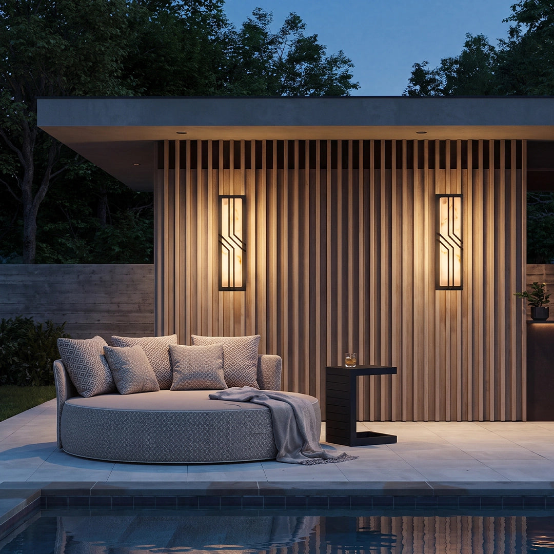 Black outside wall lights installed beside a modern front entrance with stone exterior walls.