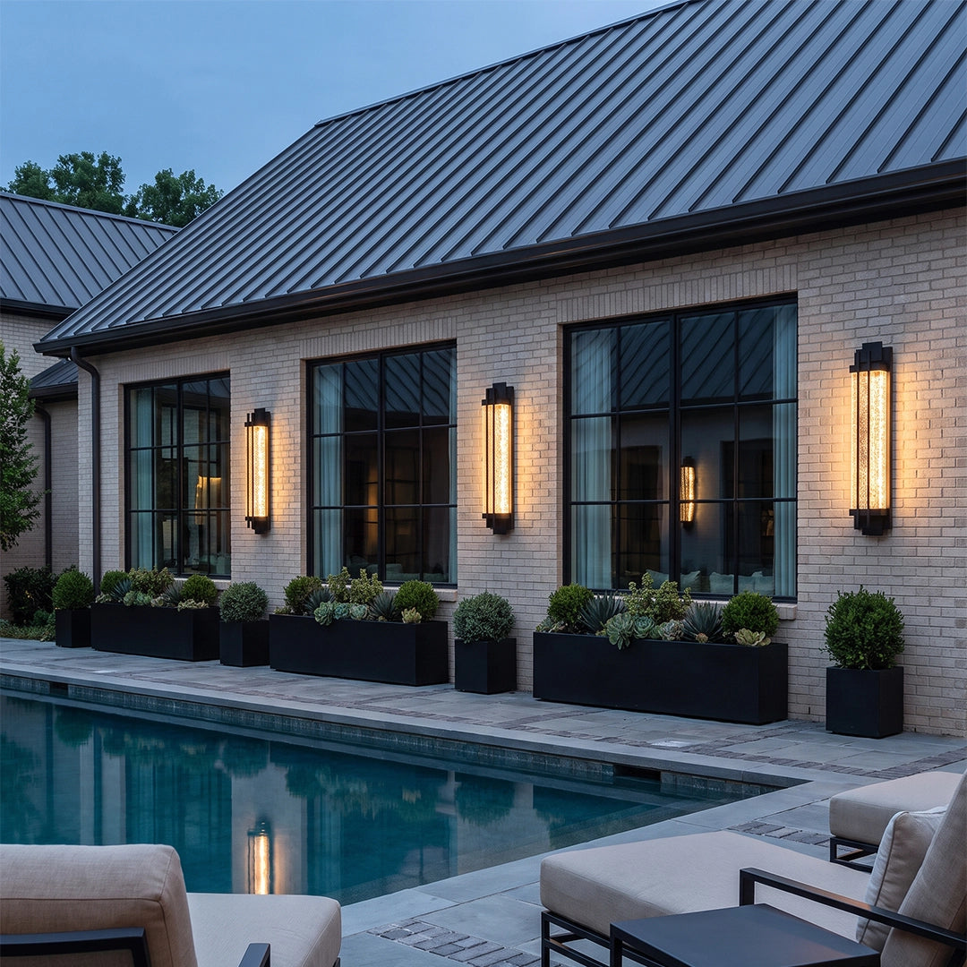 Black outside wall lights installed along a poolside brick wall for modern exterior illumination.