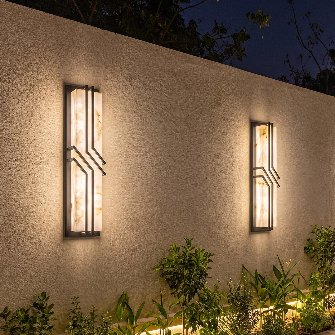 Black outside wall lights installed along a modern poolside exterior with white brick walls.