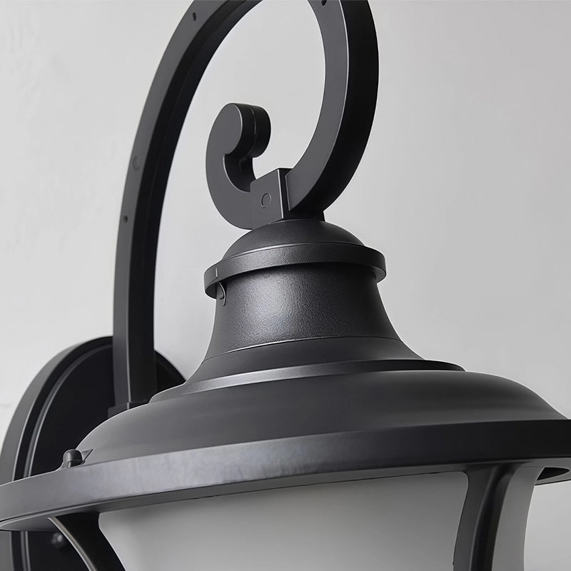 Black outside wall lights close-up showing the decorative scroll arm and classic lantern top.