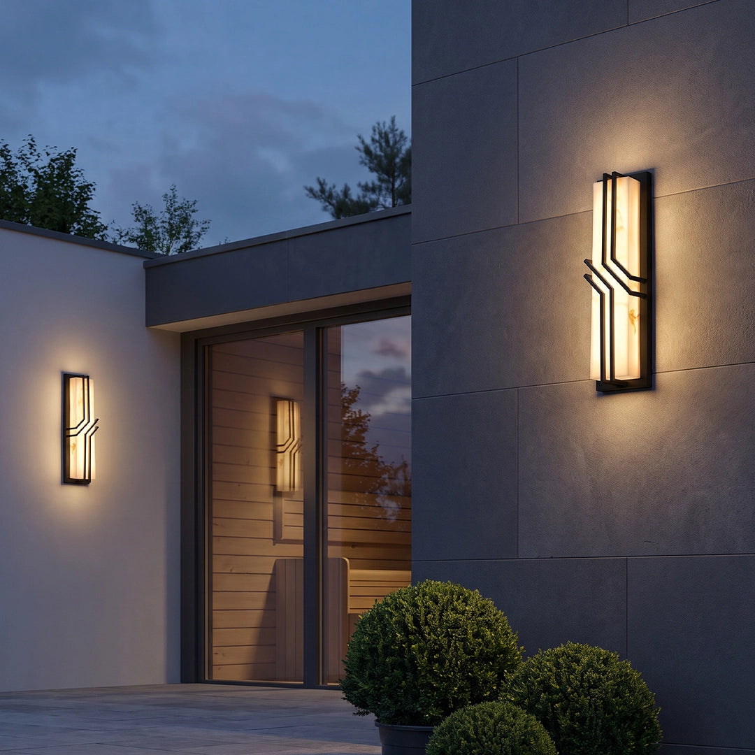 Black outside wall lights in a tall narrow design with warm LED illumination and dark metal accents.