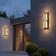 Black outside wall lights in a tall narrow design with warm LED illumination and dark metal accents.