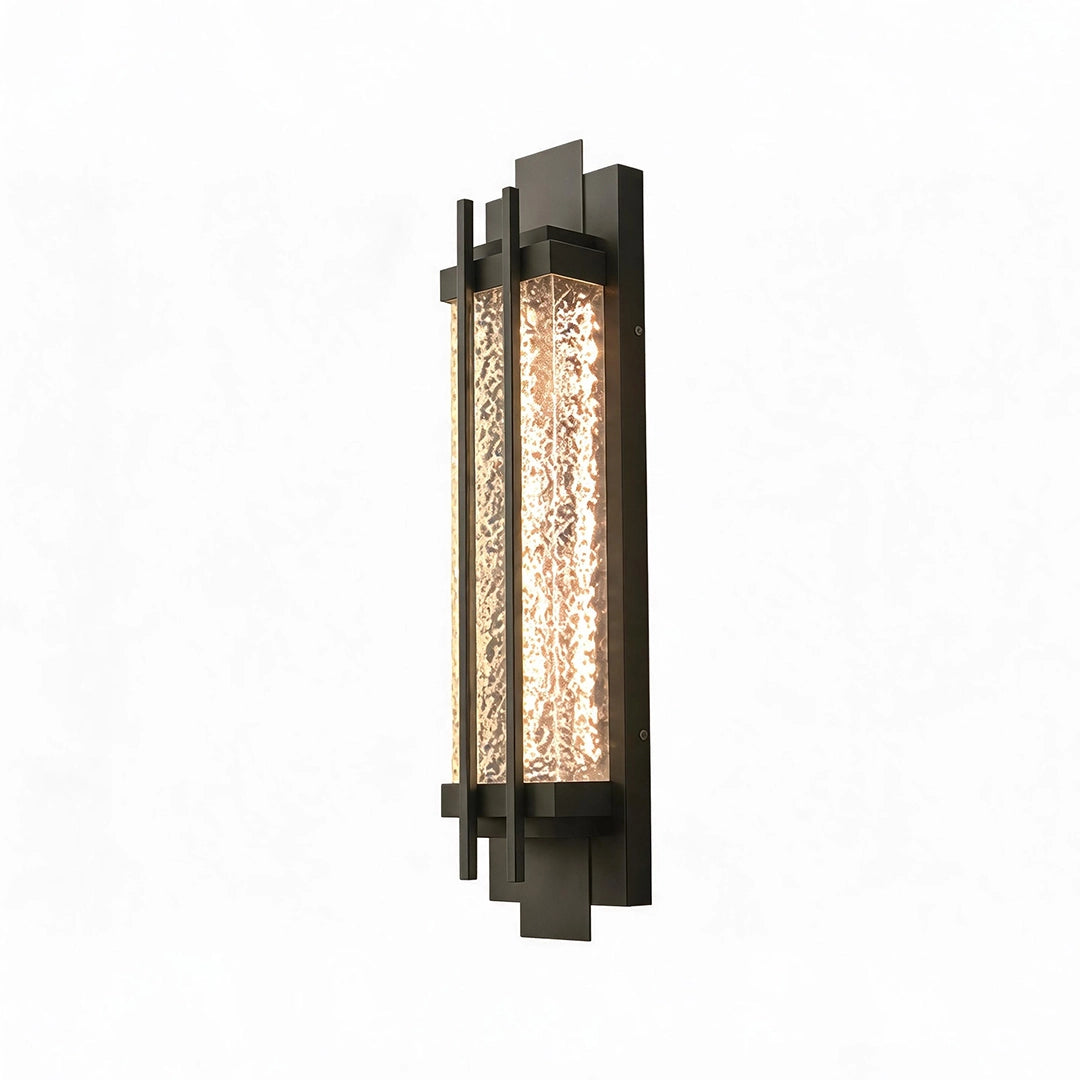 Black outside wall lights with a tall geometric frame and warm illuminated textured glass.