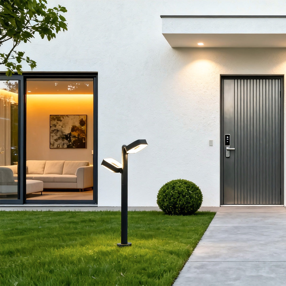 Black path light enhancing a modern home entrance with soft illumination along the walkway.