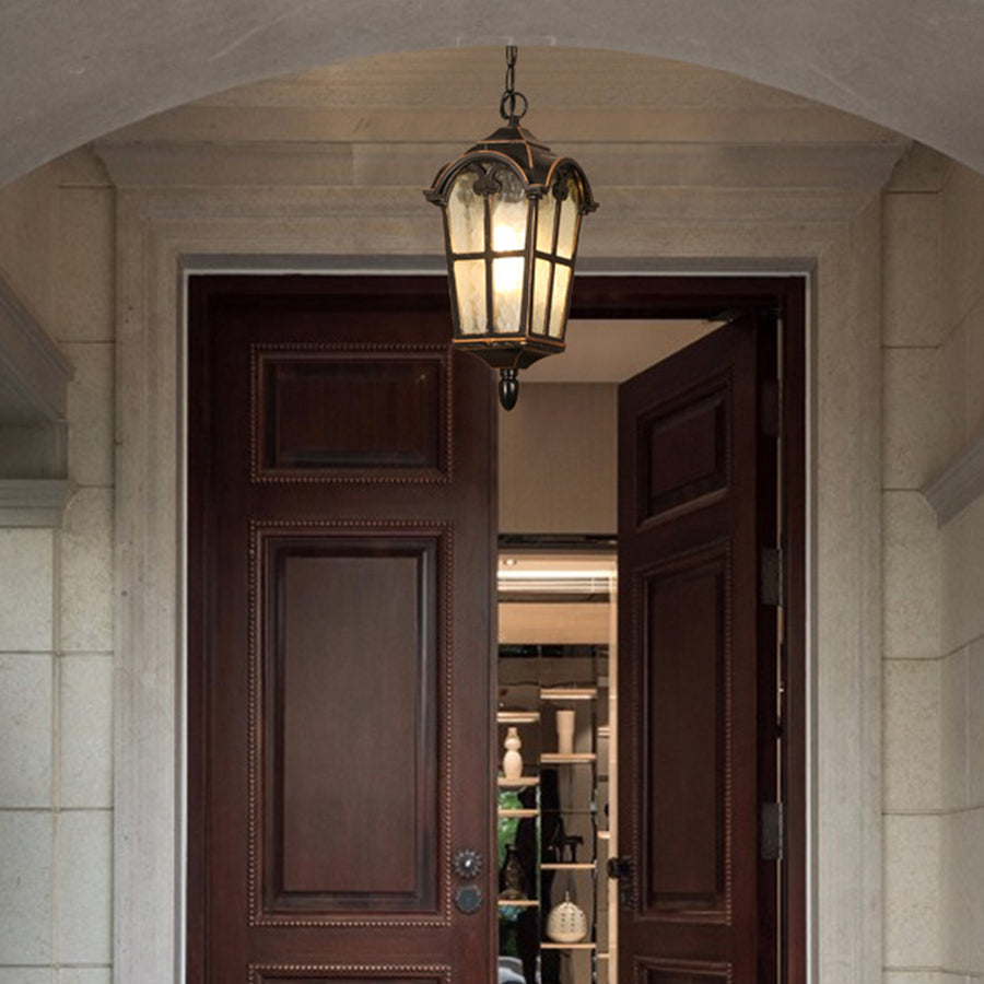 Traditional black pendant lantern with seeded glass in covered building entrance