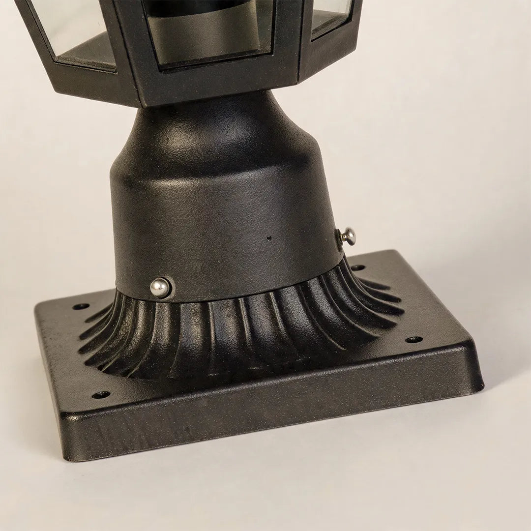 Black pillar light base detail highlighting the textured metal finish and sturdy mounting design.
