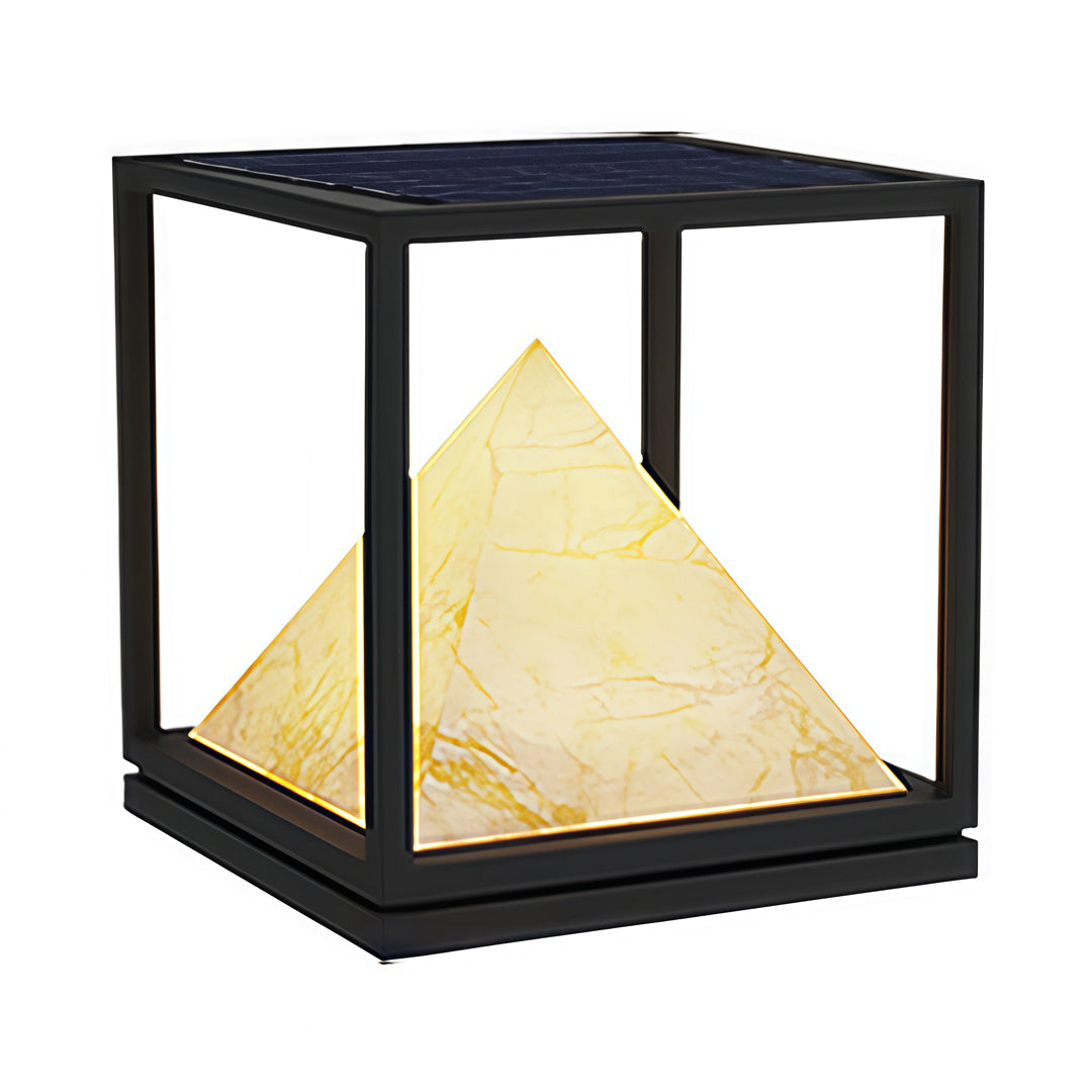 Warm-lit pyramid pillar lights integrated into modern residential gate landscaping.