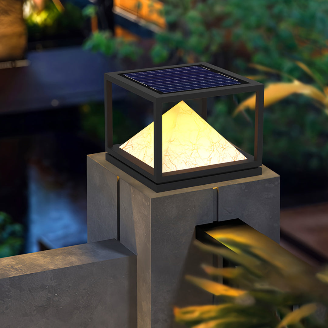 Outdoor architectural setting featuring modern pyramid lanterns arranged in cohesive light pillar design.