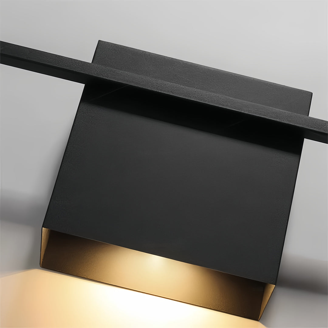 Close-up detail of decor wall lights showing black rectangular fixture with warm LED illumination