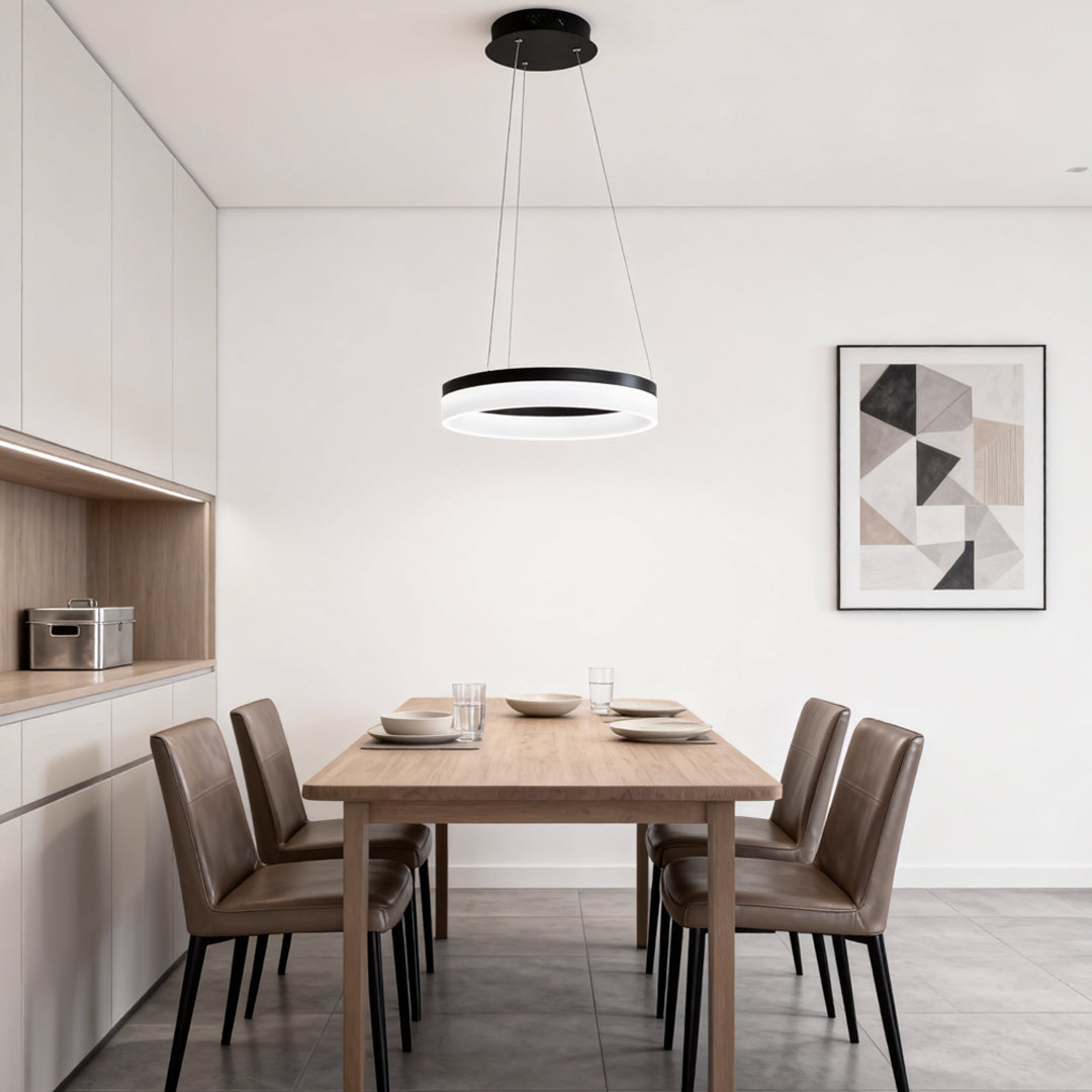 Minimal black ring pendant light centered above a dining table in a contemporary dining room.