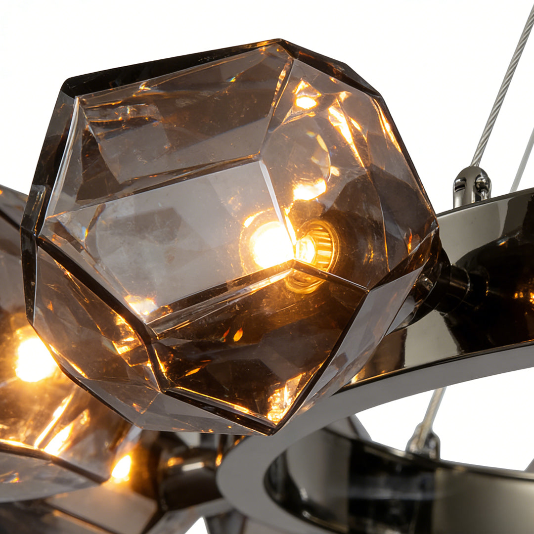Modern black round chandelier featuring geometric smoked glass shades and sleek metal frame, illuminated warmly.
