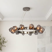 Modern black round chandelier with smoky geometric glass rock shades on a dark chrome frame.