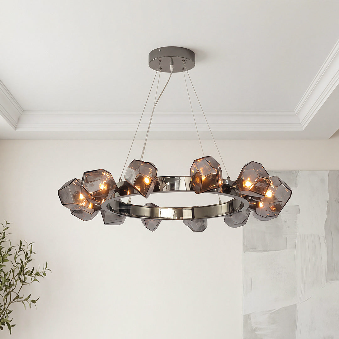 Modern black round chandelier with smoky geometric glass rock shades on a dark chrome frame.