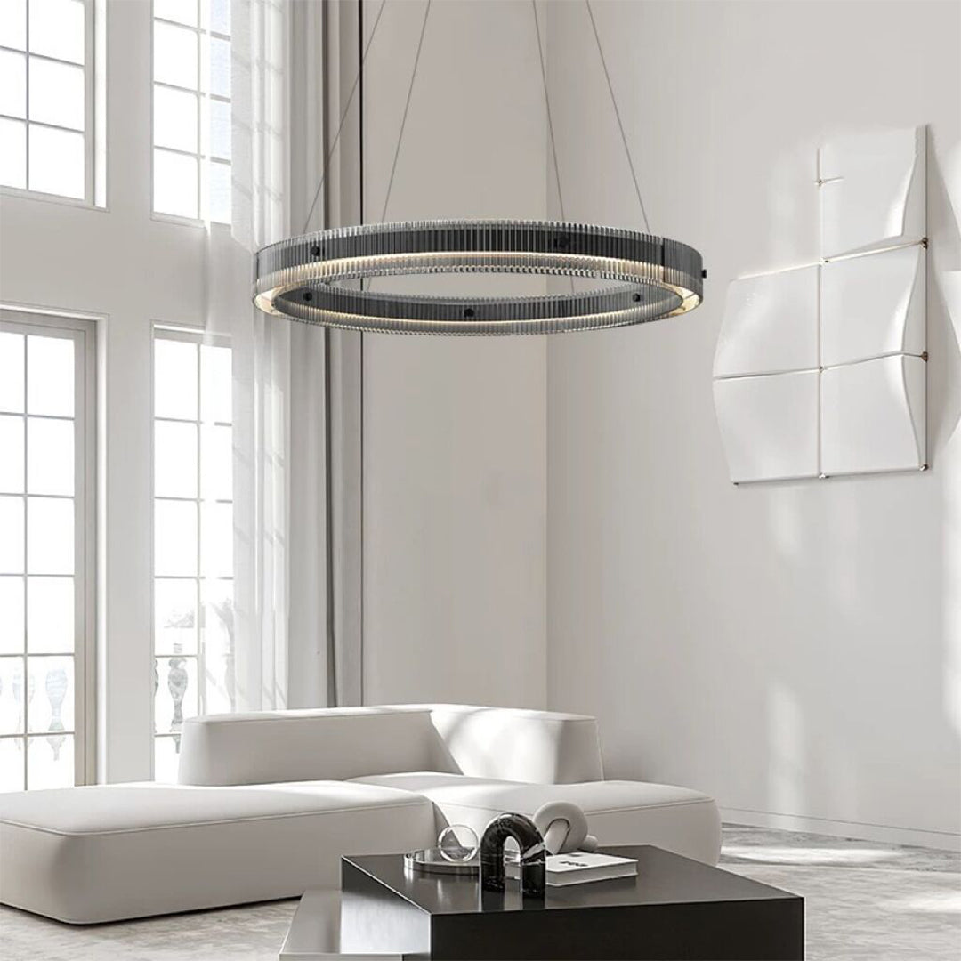 Black round pendant light installed in bright modern living room with floor-to-ceiling windows